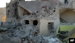 FILE - This photo provided by the Shafak Charity Organization, which has been authenticated based on its contents and other AP reporting, shows shows the badly damaged exterior of a medical facility dedicated to women after it was hit by four airstrikes.