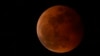 FILE - The moon rises during a lunar eclipse in metro Manila, Philippines, Nov. 8, 2022. A similar event, visible from the Western Hemisphere, will happen March 13, 2025.