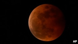 FILE - The moon rises during a lunar eclipse in metro Manila, Philippines, Nov. 8, 2022. A similar event, visible from the Western Hemisphere, will happen March 13, 2025.