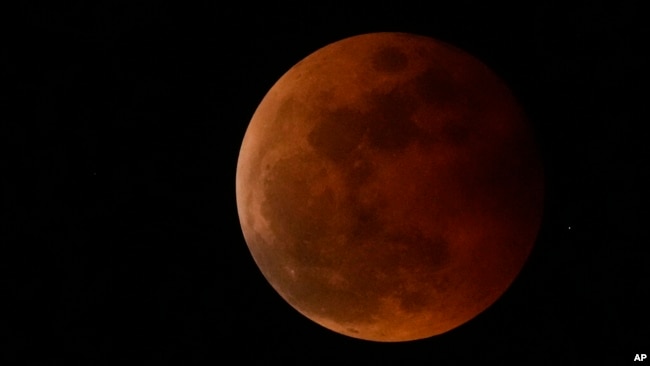 FILE - The moon rises during a lunar eclipse in metro Manila, Philippines, Nov. 8, 2022. A similar event, visible from the Western Hemisphere, will happen March 13, 2025.