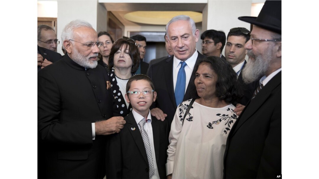 Indian Prime Minister Narendra Modi, left, with Israeli Prime Minister Benjamin Netanyahu, center right, meet with with Moshe Holtzberg, center, an Israeli boy whose parents were killed in the Nov. 26, 2008 terrorist attack on Mumbai.