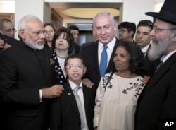 Indian Prime Minister Narendra Modi, left, with Israeli Prime Minister Benjamin Netanyahu, center right, meet with with Moshe Holtzberg, center, an Israeli boy whose parents were killed in the Nov. 26, 2008 terrorist attack on Mumbai.