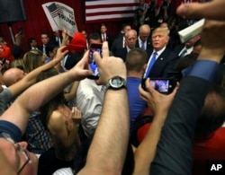 Republican presidential candidate Donald Trump, center right, greets supporters after speaking at a campaign event, May 19, 2016 in Lawrenceville, N.J.