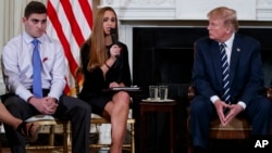 (L-R) Marjory Stoneman Douglas High School student Jonathan Blank, Julia Cordover, the student body president at Marjory Stoneman Douglas High School, President Donald Trump, participate in a listening session with high school students, teachers, and others in the State Dining Room of the White House in Washington.