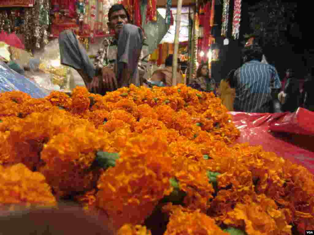 A man sells flowers and trinkets for the Diwali festival, Lucknow, India Nov. 3, 2013. (Aru Pande/VOA)