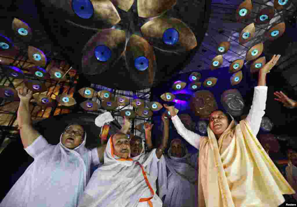 Widows sing and dance inside a marquee where an idol of Hindu goddess Durga is installed ahead of the Durga Puja festival in Kolkata, India.
