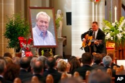 Country artist Vince Gill performs during a memorial service for golfer Arnold Palmer in the Basilica at St. Vincent's College in Latrobe, Pennsylvania, Oct. 4, 2016.