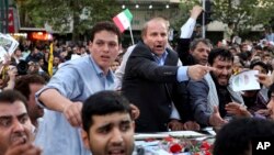 FILE - Iranian presidential candidate, Mohammad Bagher Qalibaf, who is also Tehran's mayor, points, during a campaign rally in Tehran, Iran, June 12, 2013.
