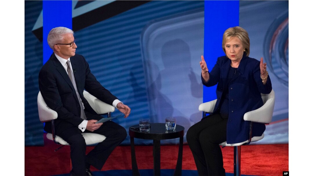 Democratic presidential candidate Hillary Clinton, right, speaks alongside host Anderson Cooper during a Democratic primary town hall sponsored by CNN, in Derry, N.H., Feb. 3, 2016.