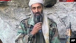 This image made from video broadcast on Sunday, Oct. 7, 2001 shows Osama bin Laden at an undisclosed location. Al-Qaida leader Osama bin Laden threatened in a new audio tape to kill French citizens to avenge their country's support for the U.S.-led war in