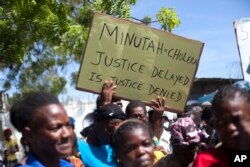 FILE - Cholera survivors protest the United Nations peacekeeping mission outside U.N. headquarters in Port-au-Prince, Haiti.