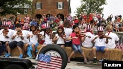 Violinists play patriotic songs during the Independence Day parade in Fairfax, Virginia, July 4, 2015. 