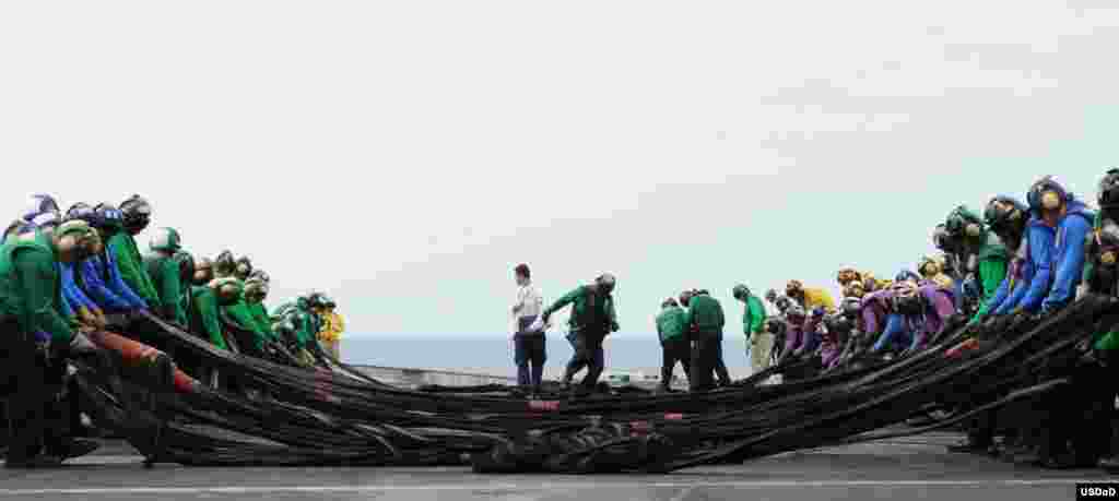 Sailors set up an emergency aircraft barricade during flight deck training drills aboard the aircraft carrier USS George H.W. Bush (CVN 77). George H.W. Bush is conducting a tailored ship&#39;s training availability and final evaluation problem in the Atlantic Ocean. (U.S. Navy photo by Mass Communication Specialist Seaman Brian Stephens)