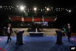 Students take positions behind the podium for a dress rehearsal Oct. 18, 2016, before the third presidential debate between Republican presidential nominee Donald Trump and Democratic presidential nominee Hillary Clinton at UNLV in Las Vegas.