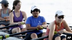 FILE - Manasi Gopala, second from right, rows during her sculling class at Lake Wheeler in Raleigh, N.C., Aug. 30, 2016. When Gopala immigrated to America, she finally got the chance to row crew. 