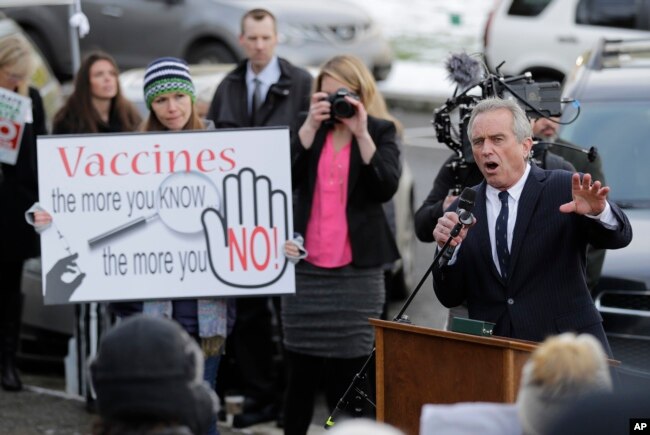 Robert Kennedy Jr., right, speaks at a rally held in opposition to a proposed bill that would remove parents' ability to claim a philosophical exemption to opt their school-age children out of the combined measles, mumps and rubella vaccine, Feb. 8, 2019, at the Capitol in Olympia, Wash.