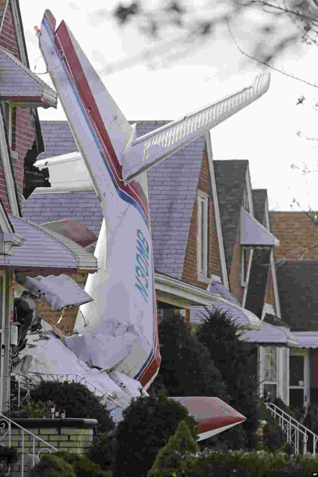 The wreckage of a small twin-engine cargo plane lies where the aircraft crashed into a home on Chicago&#39;s southwest side. The Aero Commander 500 had taken off from Midway International Airport and it slammed into the front of the home and plunged into the basement.