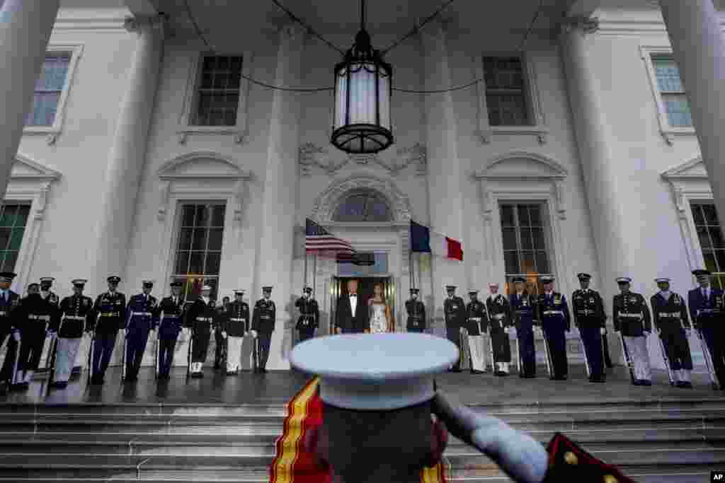 President Donald Trump and first lady Melania Trump prepare to greet French President Emmanuel Macron and his wife Brigitte Macron as they arrive for a State Dinner at the White House in Washington, April 24, 2018. 