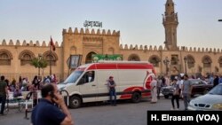 FILE - Ambulances wait to aid people who collapse from heat at Amr Ibn al-As mosque, in old Cairo, Egypt, May 31, 2019.