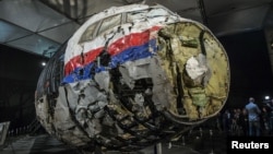 FILE - A portion of the reconstructed wreckage of the Malaysian Airlines flight MH17 downed over eastern Ukraine is seen in Gilze Rijen, the Netherlands, Oct. 13, 2015.