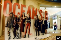 An oversized movie advertisement for the upcoming film "Ocean's 8," featuring an all-female starring cast, is pictured on day one of CinemaCon 2018, the official convention of the National Association of Theatre Owners, at Caesars Palace in Las Vegas, April 23, 2018.