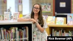 First-grade teacher Hillary Madrigal is photographed at her school Thursday, Aug. 22, 2019, in Salt Lake City. Madrigal went to a new district that paid her more, and means she quit her second job as a housekeeper and can buy a new car.