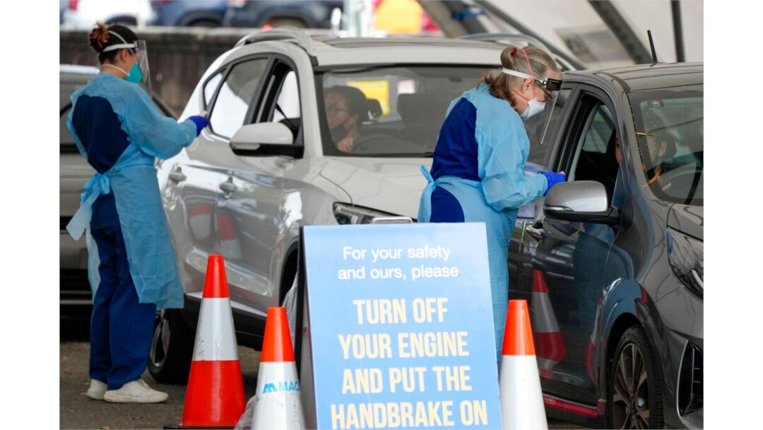 Personnel take samples for COVID-19 tests at a drive-thru testing facility set up in Bondi Beach, in Sydney, Australia, Jan. 8, 2022.