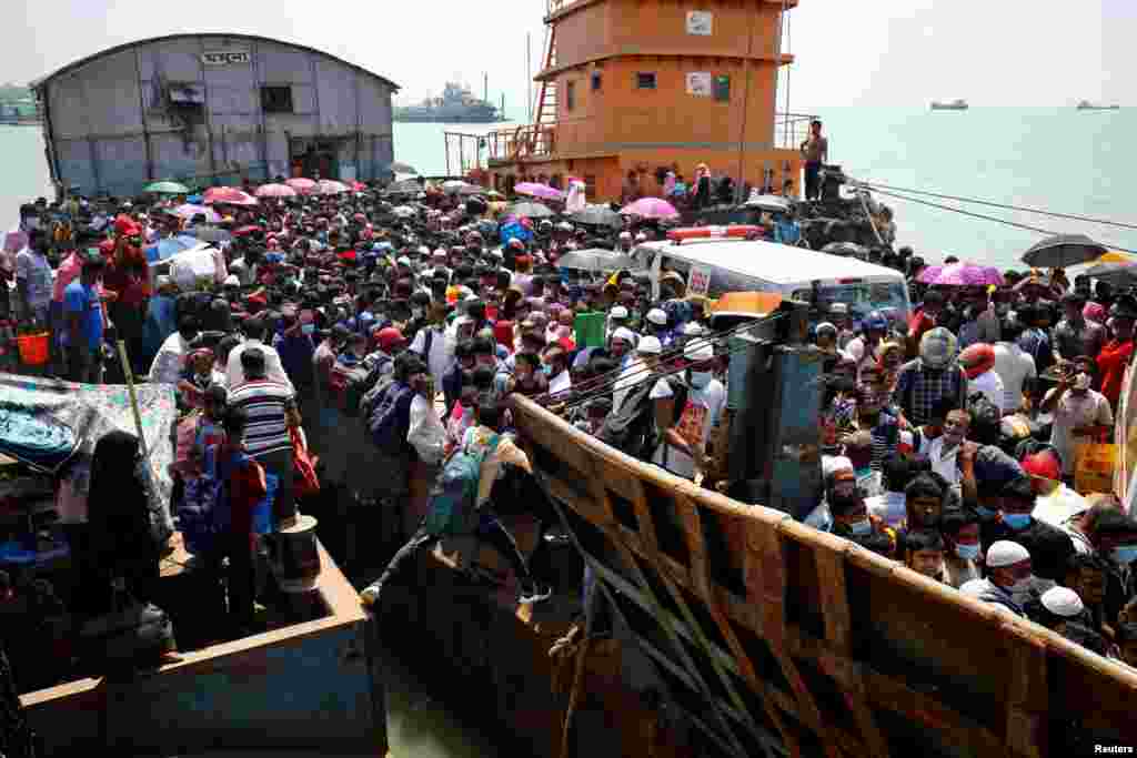 Migrant people board an overcrowded ferry to get home to celebrate Eid al-Fitr, after government imposed restrictions on long route public transports amid concerns over the COVID-19 outbreak, in Munshiganj, Bangladesh.