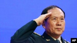 Chinese Defense Minister Gen. Wei Fenghe salutes attendees ahead of the fourth plenary session of the 18th International Institute for Strategic Studies Shangri-la Dialogue, an annual defense and security forum in Asia, in Singapore, June 2, 2019.