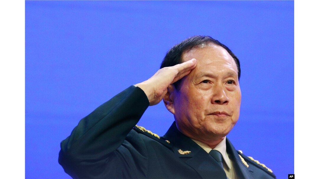 Chinese Defense Minister Gen. Wei Fenghe salutes attendees ahead of the fourth plenary session of the 18th International Institute for Strategic Studies Shangri-la Dialogue, an annual defense and security forum in Asia, in Singapore, June 2, 2019.
