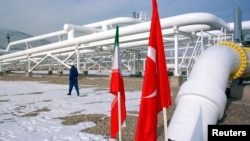 A worker walks past the pumping station on the border between Iran and Turkey during the inauguration ceremony for the Iran-Turkey gas pipeline, January 22, 2002. 