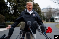 FILE - President Donald Trump talks with reporters outside the White House in Washington.