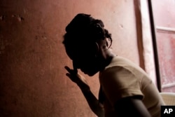 FILE - Martine Gestime 32, wipes her tears during an interview in Port-au-Prince, Haiti. Gestime said she was raped by a Brazilian peacekeeper in 2008 and became pregnant with her son, Ashford.