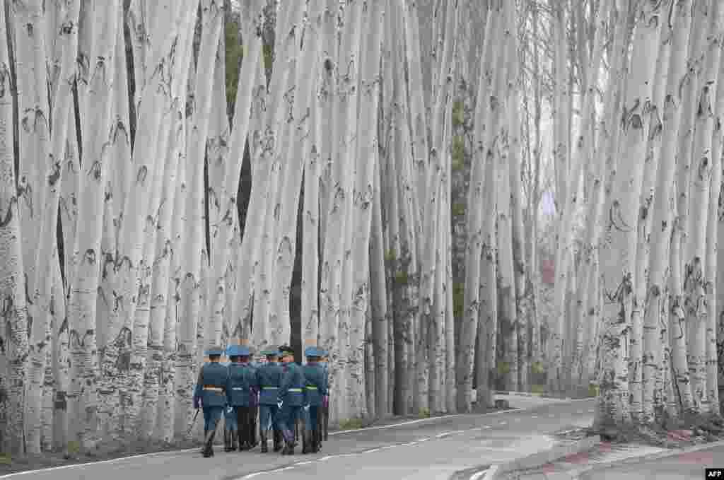 Kyrgyz guards of honor walk away after a welcoming ceremony attended by Presidents Vladimir Putin of Russia and Sooronbay Jeenbekov of Kyrgyzstan in Bishkek.