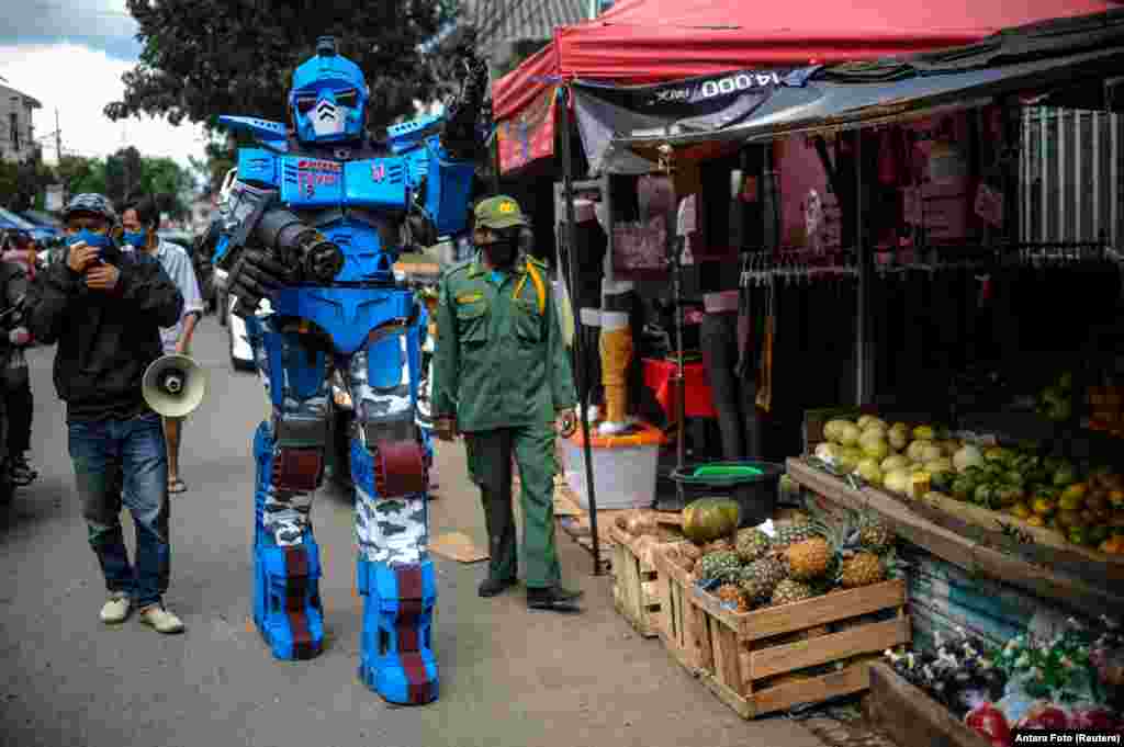 A man wearing a Transformers costume appeals to the citizens to stay at a home amid coronavirus disease (COVID-19) outbreak, in Bandung, West Java Province, Indonesia.