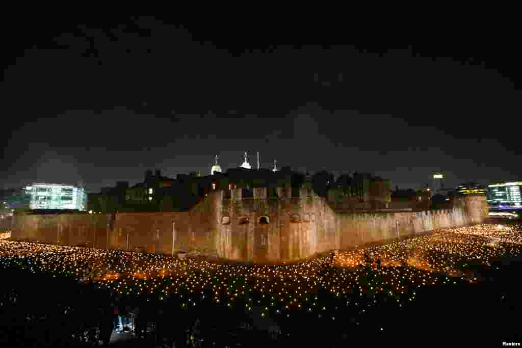 The moat of the Tower of London are seen filled with thousands of lit torches as part of the installation &#39;Beyond the Deepening Shadow&#39;, in London, Nov. 4, 2018.