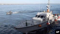A Spanish Guardia Civil boat (L) sails near a rapid deployment boat belonging to the French patrol boat Arago involved in a survey operation from Almeria harbor as part of the "Indalo" illegal immigrants drill operation organized by the European Union's b