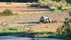 FILE - In this Oct. 16, 2017 file photo, the wreckage of the car of investigative journalist Daphne Caruana Galizia lies next to a road in the town of Mosta, Malta.