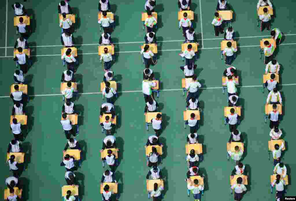 Students play Chinese chess during a school competition in Shenyang, Liaoning province, China.