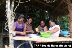 Melissa Espinoza Paez, her mother Nora Paez Mayorga, Basilia Jackson Jackson and her daughter Flor Dias Jackson, prepare cacao at the Siwakabata agro-ecology farm, Talamanca, Costa Rica, May 10, 2018.
