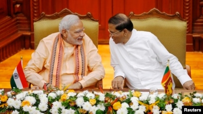 India's Prime Minister Narendra Modi shakes hands with Sri Lanka's  President Maithripala Sirisena during his welcome ceremony at the  Presidential Secretariat in Colombo