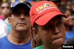 A supporter of Venezuela's President Nicolas Maduro wears a cap that reads, "Chavez, heart of my homeland," as she attends a rally against the application of Organization of American States (OAS) democratic charter, in Caracas, Venezuela, June 23, 2016.