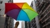 A participant holds a rainbow umbrella as he attends a lesbian, gay, bisexual and transgender (LGBT) Pride Parade in Hong Kong, Nov. 8, 2014. Participants from the LGBT communities took to the streets to demonstrate for their rights.