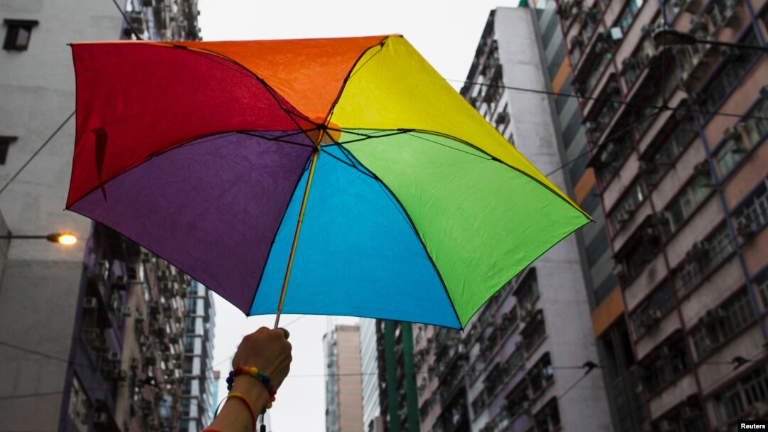 A participant holds a rainbow umbrella as he attends a lesbian, gay, bisexual and transgender (LGBT) Pride Parade in Hong Kong, Nov. 8, 2014. Participants from the LGBT communities took to the streets to demonstrate for their rights.