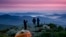 Robert Weiss of Tewksbury, Mass., left, photographs his brother-in-law, Matthew Ferri, of Dracut, Mass., and his wife, Andrea Weiss just before sunrise from their campsite on the Appalachian Trail in Beans Purchase, N.H., Sunday, Sept. 17, 2017. (AP Photo/Robert F. Bukaty)