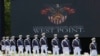 FILE - United States Military Academy graduating cadets, wearing face masks, march to their socially-distanced seats during commencement ceremonies in West Point, New York, June 13, 2020.