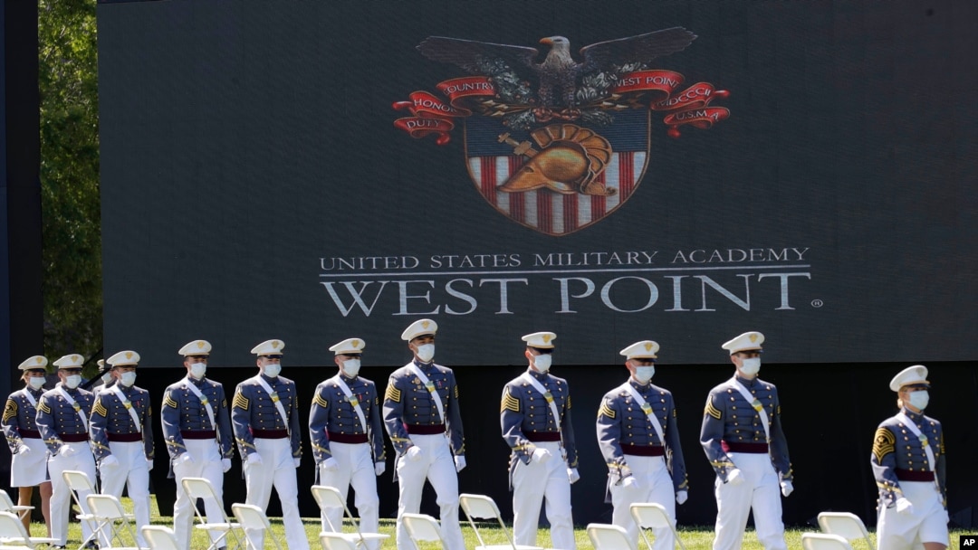 FILE - United States Military Academy graduating cadets, wearing face masks, march to their socially-distanced seats during commencement ceremonies in West Point, New York, June 13, 2020.
