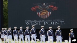 FILE - United States Military Academy graduating cadets, wearing face masks, march to their socially-distanced seats during commencement ceremonies in West Point, New York, June 13, 2020.