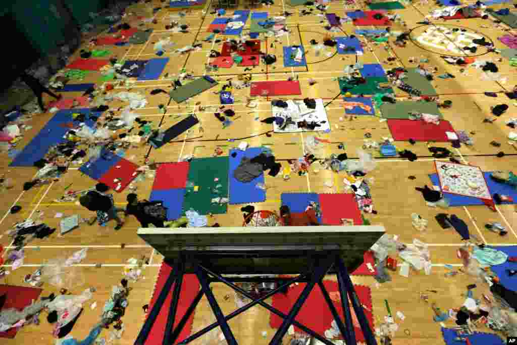 Protesters walk in a gymnasium on the campus of the Polytechnic University in Hong Kong.