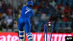 Afghanistan's Mohammad Nabi gets clean bowled by South Africa's Kagiso Rabada (out of frame) during the ICC men's Twenty20 World Cup 2024 semi-final cricket match between South Africa and Afghanistan at Brian Lara Cricket Academy in Tarouba, Trinidad and 